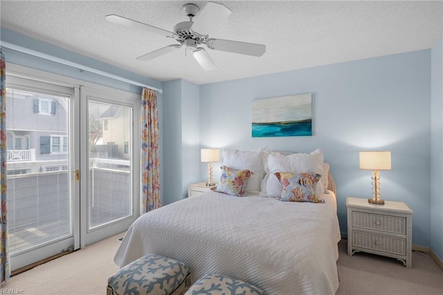 carpeted bedroom with ceiling fan, access to exterior, and a textured ceiling