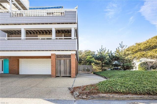 view of front of property with a garage and a balcony