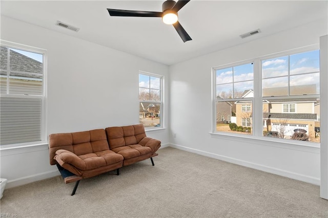 sitting room featuring light colored carpet and ceiling fan