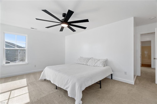 bedroom featuring ceiling fan and light colored carpet