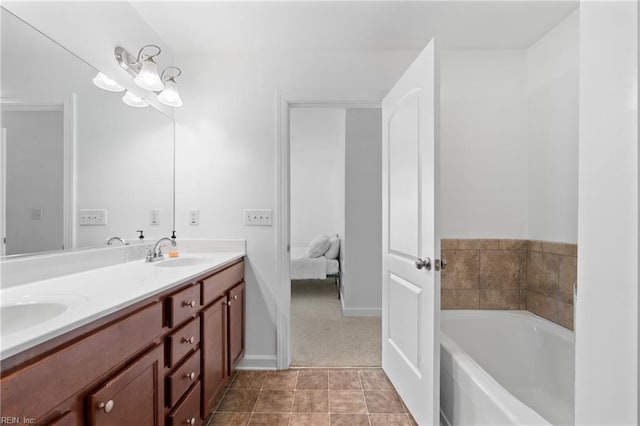 bathroom with a tub to relax in, tile patterned flooring, and vanity