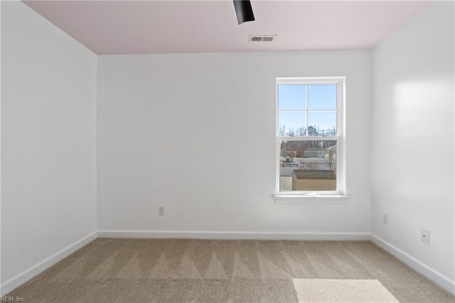 unfurnished room featuring light colored carpet