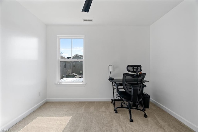 office area featuring light carpet