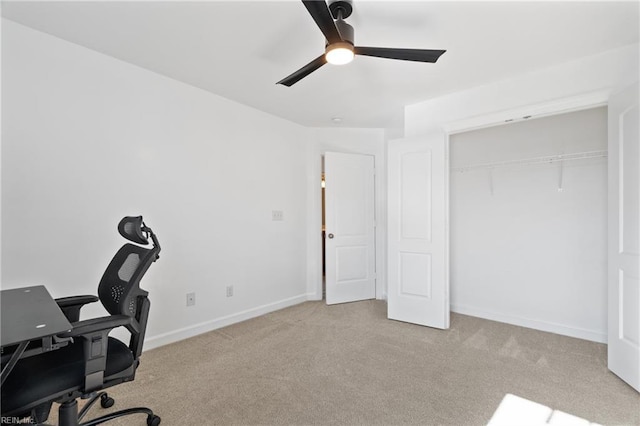 carpeted office space with ceiling fan