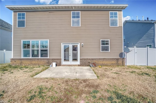 rear view of house featuring a yard and a patio