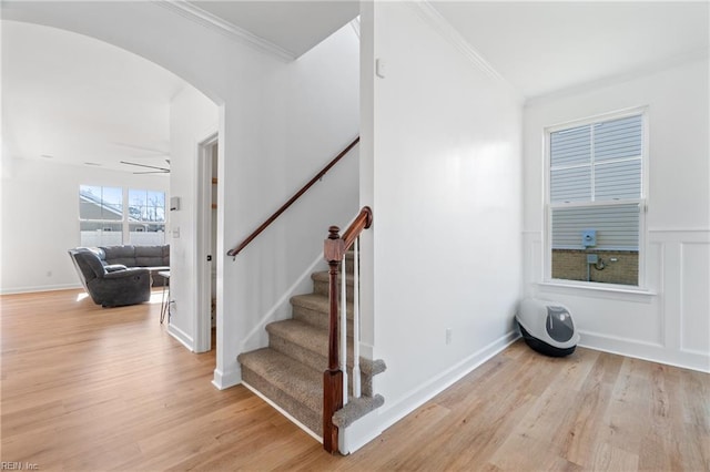 stairway featuring wood-type flooring and ornamental molding