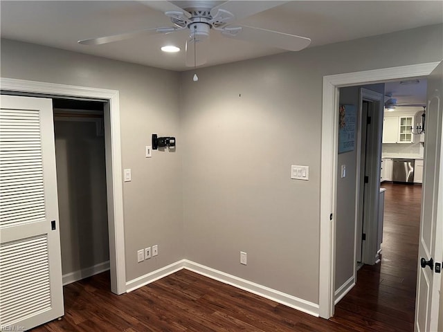 unfurnished bedroom with ceiling fan, dark hardwood / wood-style flooring, and a closet