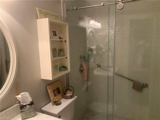 bathroom featuring an enclosed shower and toilet