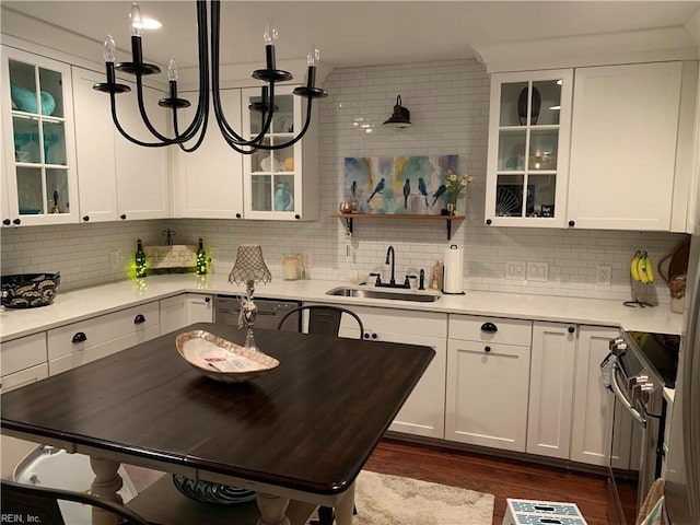 kitchen featuring stainless steel electric range oven, sink, and white cabinets