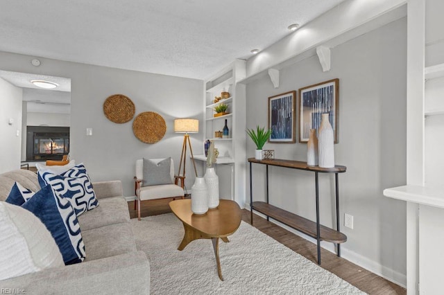 living room with hardwood / wood-style floors and a textured ceiling