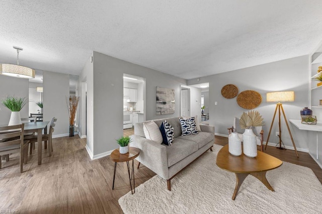 living room with hardwood / wood-style floors and a textured ceiling