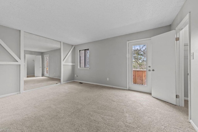 interior space with light carpet and a textured ceiling