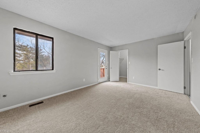 interior space featuring a textured ceiling and carpet