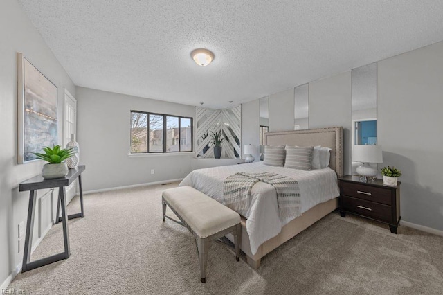 bedroom featuring light carpet and a textured ceiling