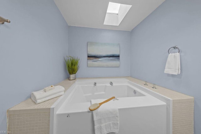 bathroom featuring a skylight and a washtub