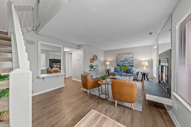 living room featuring hardwood / wood-style flooring and a textured ceiling