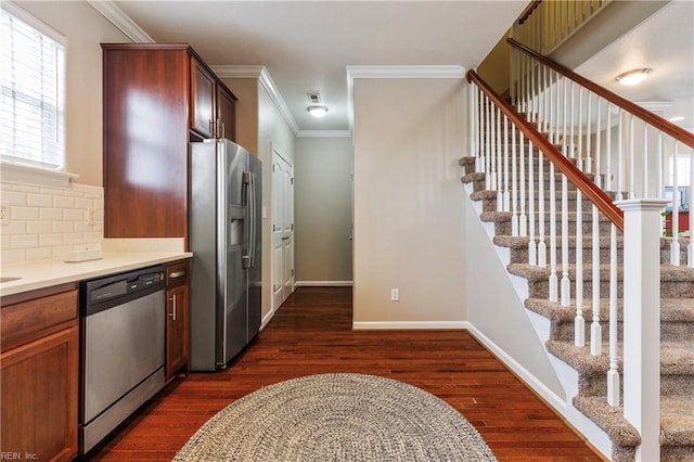 kitchen with crown molding, appliances with stainless steel finishes, dark wood-type flooring, and decorative backsplash