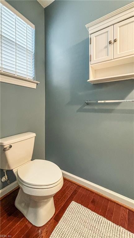 bathroom with wood-type flooring and toilet