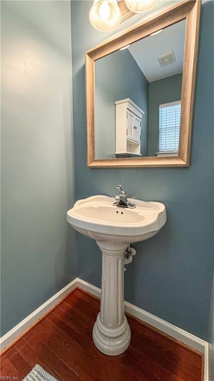 bathroom with hardwood / wood-style flooring