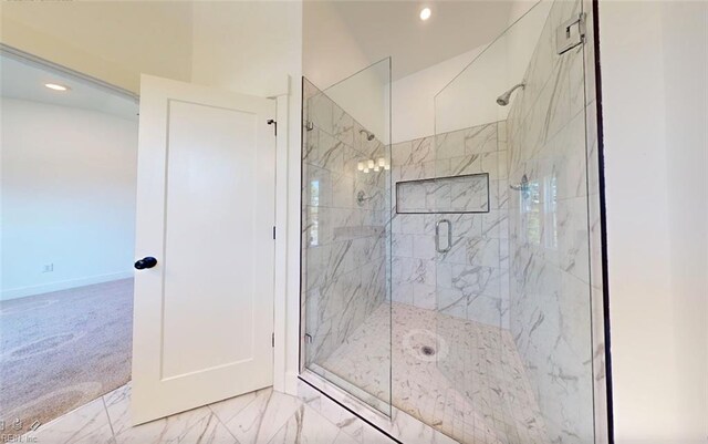 bathroom featuring a shower with shower door