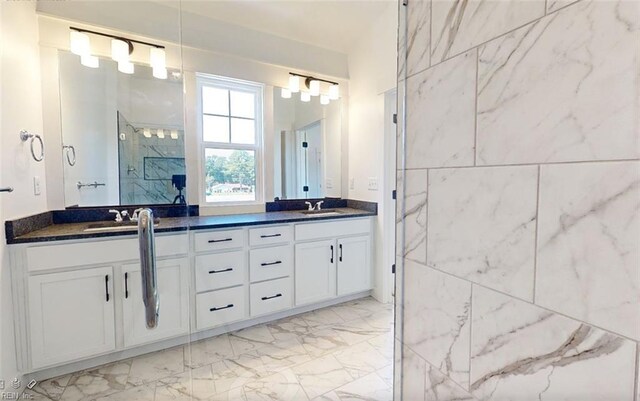 bathroom with vanity and a shower with shower door