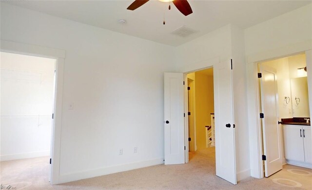 interior space featuring light colored carpet and ceiling fan