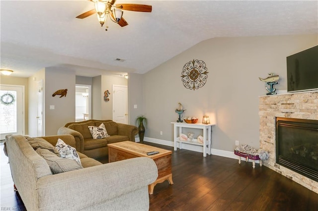 living room featuring a wealth of natural light, a fireplace, dark hardwood / wood-style floors, and vaulted ceiling