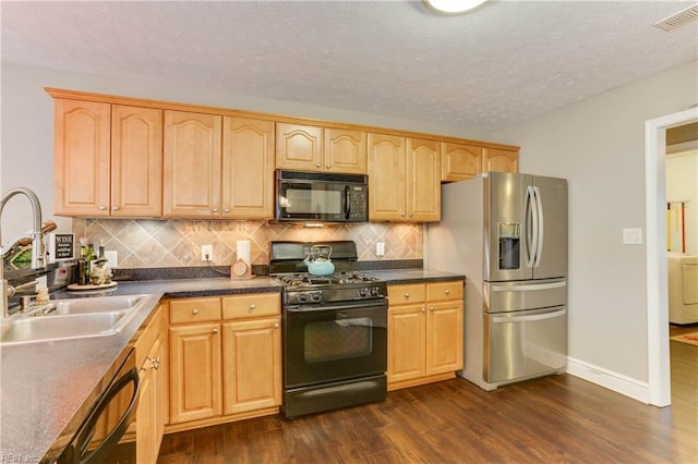 kitchen with sink, backsplash, black appliances, dark wood-type flooring, and a textured ceiling