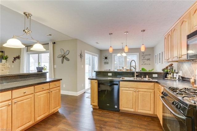 kitchen featuring light brown cabinetry, sink, decorative light fixtures, dark hardwood / wood-style floors, and black appliances