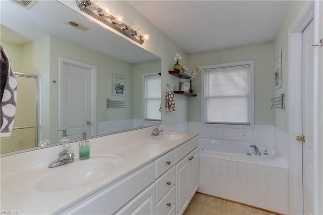 bathroom featuring vanity, tile patterned flooring, and plus walk in shower