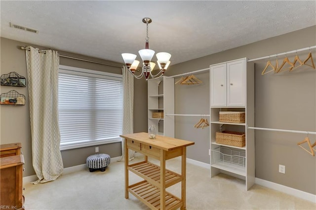 interior space featuring light colored carpet and a notable chandelier