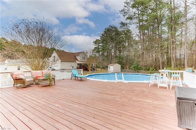 view of pool featuring a storage unit and a deck