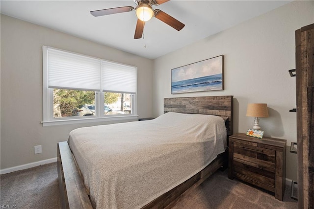 bedroom with ceiling fan and dark carpet