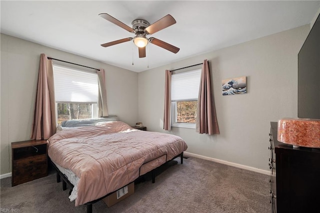 carpeted bedroom with multiple windows and ceiling fan