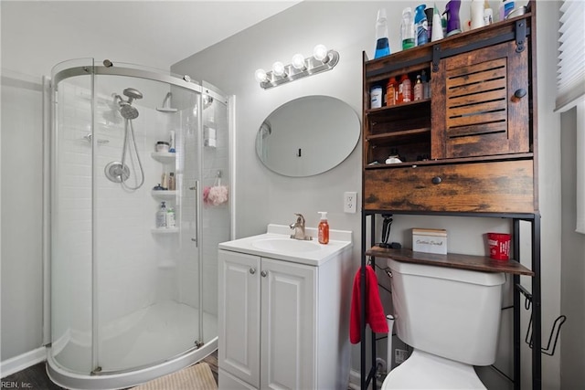 bathroom with vanity, toilet, and an enclosed shower