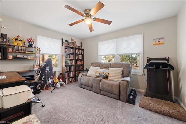 carpeted office space with ceiling fan