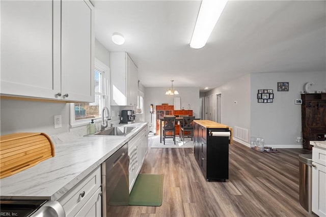 kitchen with dark wood-type flooring, wood counters, sink, dishwasher, and white cabinets