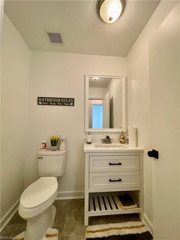 bathroom featuring vanity and toilet