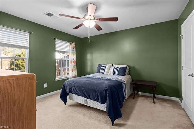 bedroom with ceiling fan and light colored carpet