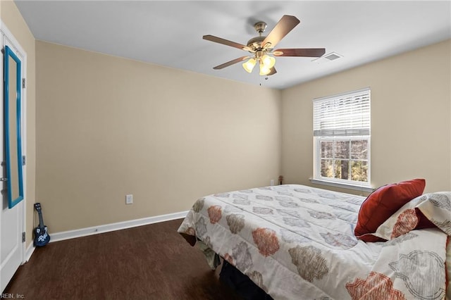 bedroom with dark hardwood / wood-style flooring and ceiling fan