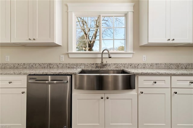 kitchen with white cabinetry, stainless steel dishwasher, light stone countertops, and sink