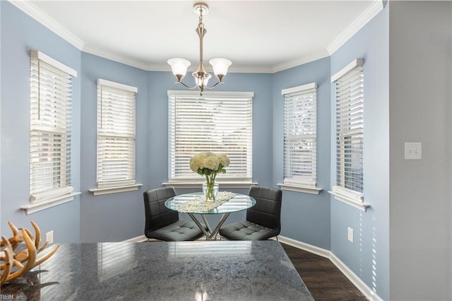 dining area featuring crown molding, dark hardwood / wood-style floors, and an inviting chandelier