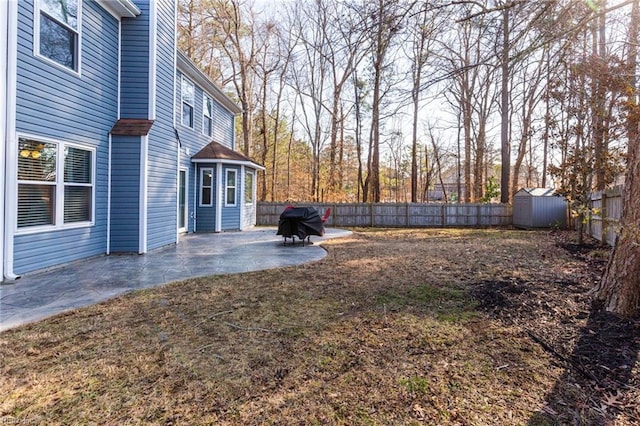 view of yard with a patio area and a storage shed