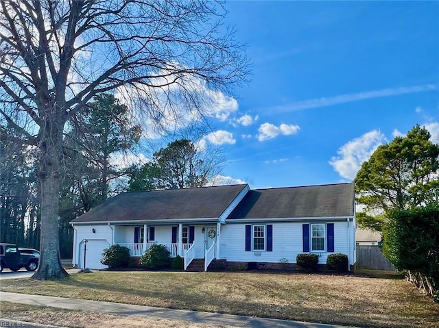 single story home featuring a garage and a front lawn