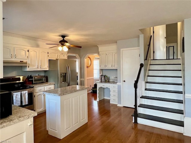 kitchen with stainless steel appliances, white cabinetry, dark wood-type flooring, and ceiling fan