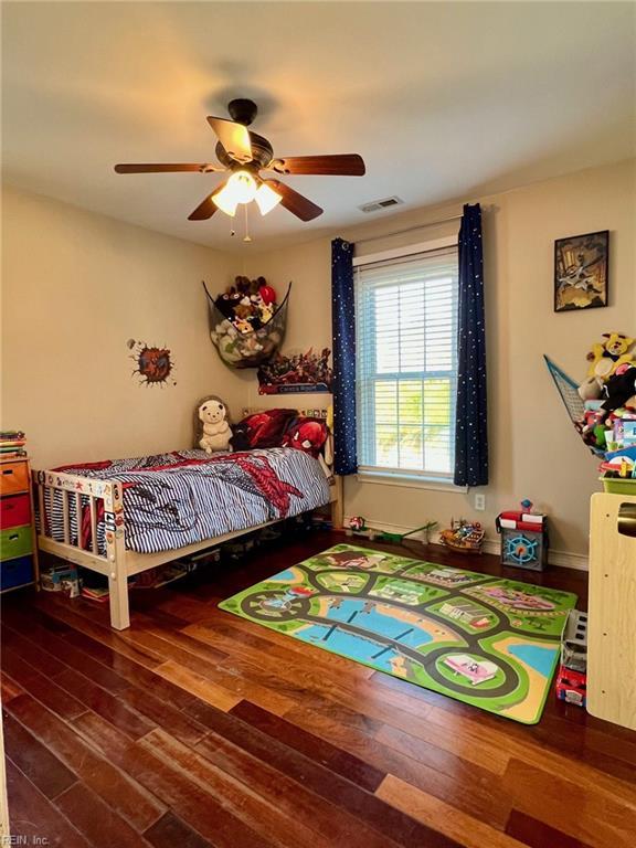 bedroom featuring ceiling fan and dark hardwood / wood-style flooring