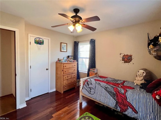 bedroom featuring dark hardwood / wood-style flooring and ceiling fan