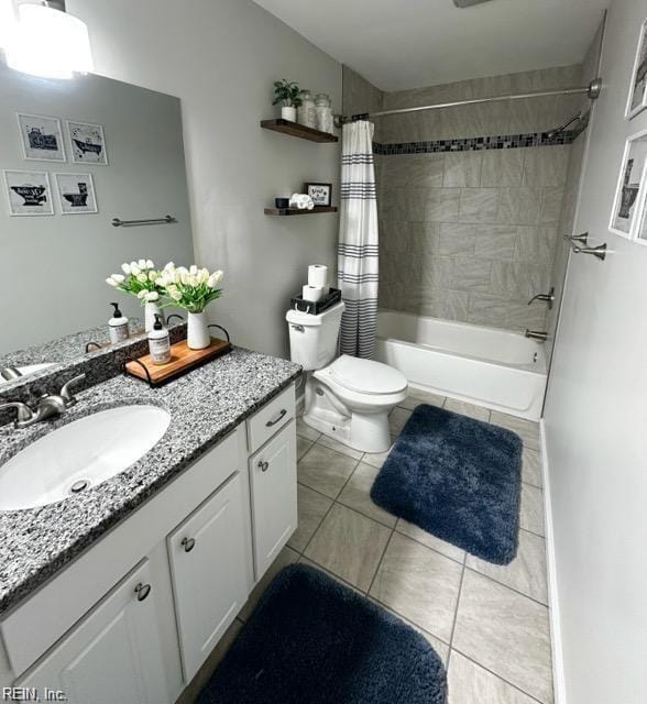 full bathroom with shower / tub combo with curtain, vanity, toilet, and tile patterned floors