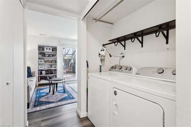 washroom featuring dark wood-type flooring and independent washer and dryer