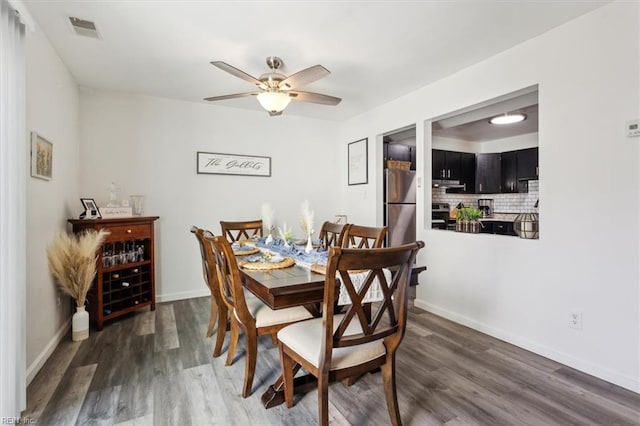 dining room featuring ceiling fan and dark hardwood / wood-style floors